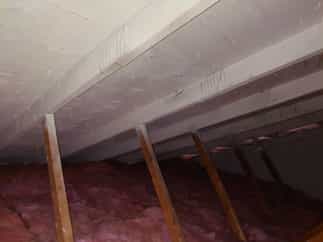 Mold removed from attic and surface sealed with white sealant.